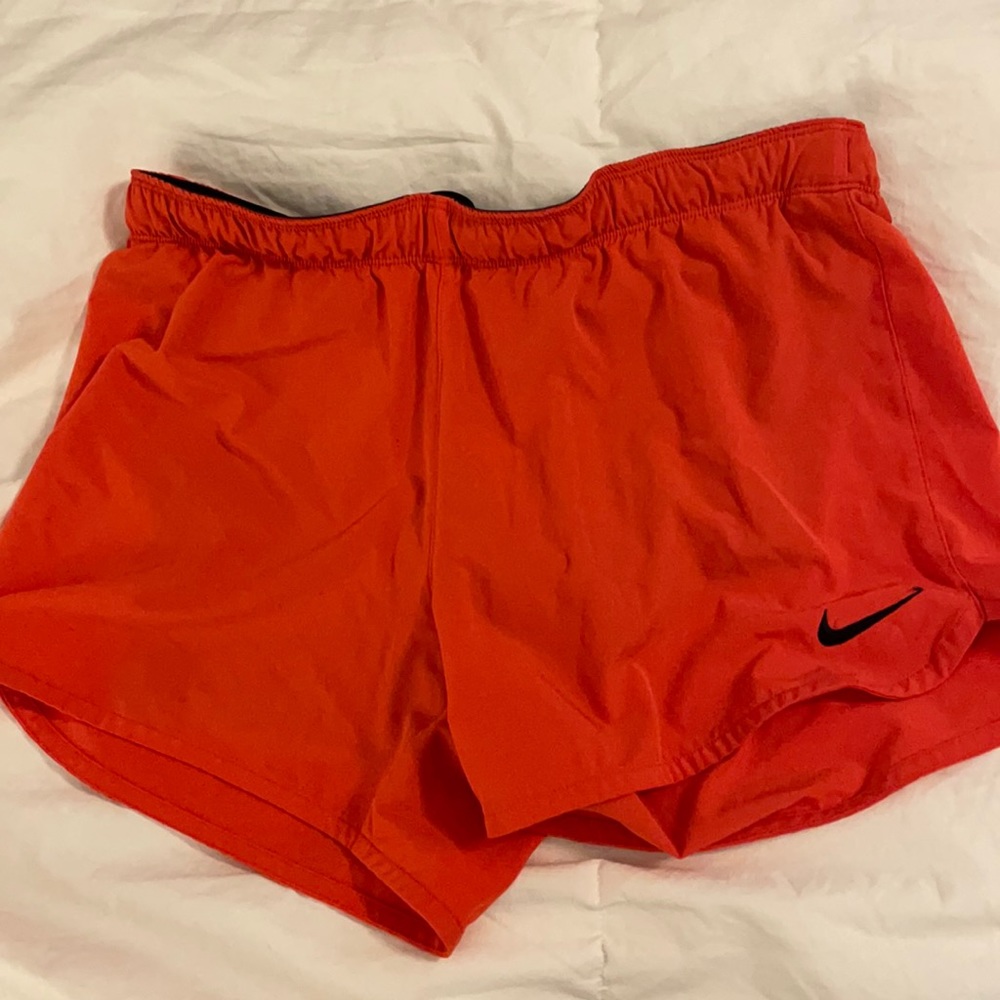 Orange Nike shorts w/ black biker shorts under.